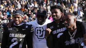 Deion Sanders poses for a photo with his sons.