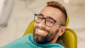 patient at dentist office in chair with smile