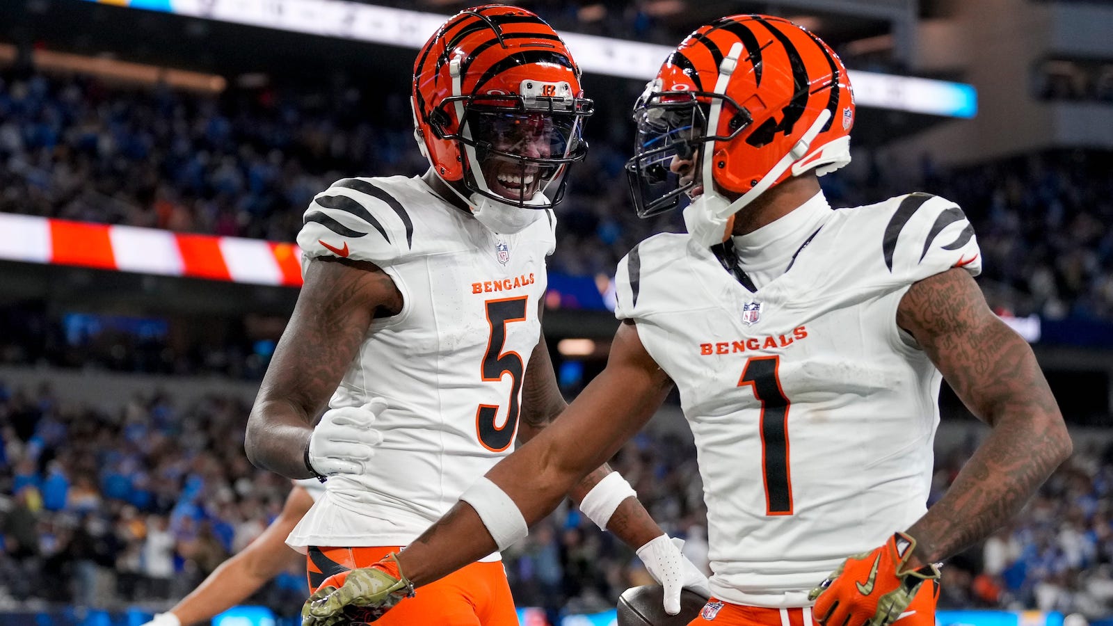 Cincinnati Bengals wide receivers Tee Higgins (5) and Ja'Marr Chase (1) celebrate a touchdown during a game on Nov. 17, 2024.