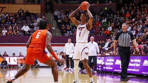 Virginia Tech basketball player Tobi Lawal looks to pass vs. Clemson.