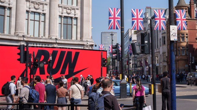 London-Marathon-shoppers-walk-past-a-themed-billboard-outside-Nike-Town