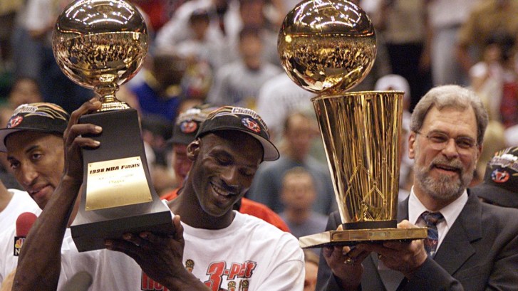 Michael Jordan showing off 1998 NBA Championship trophy