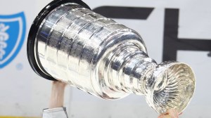 NHL player hoisting Stanley Cup
