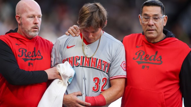 Cincinnati Reds outfielder Tyler Callihan walks off the field after breaking his arm.