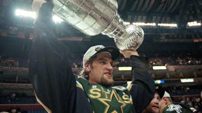 Derian Hatcher holding Stanley Cup