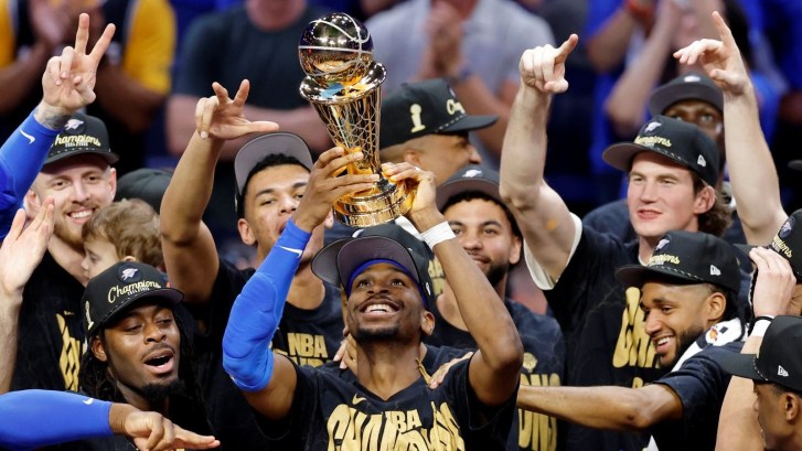 Oklahoma City Thunder player Shai Gilgeous-Alexander lifts NBA Championship trophy