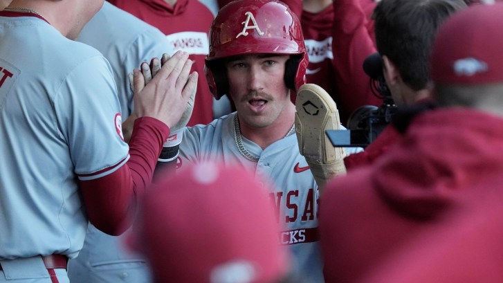 Arkansas baseball players celebrate in the dugout