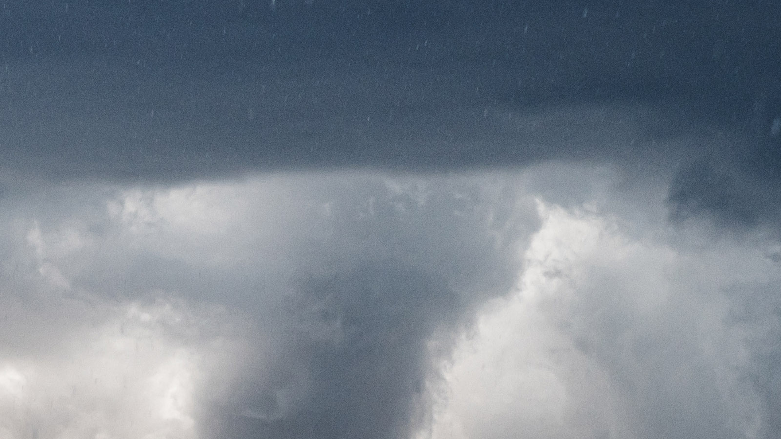 dark cloud with swirling tornado