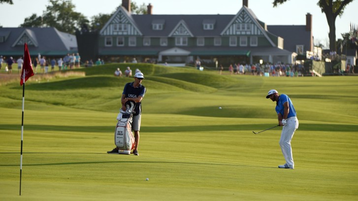 Dustin Johnson chips onto the 10th green at Oakmont Country Club