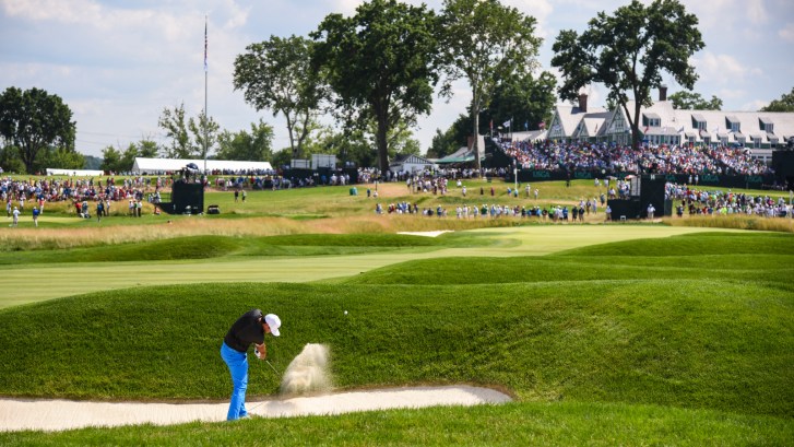 Brooks Koepa plays out of bunker on hole 14 at Oakmont Country Club