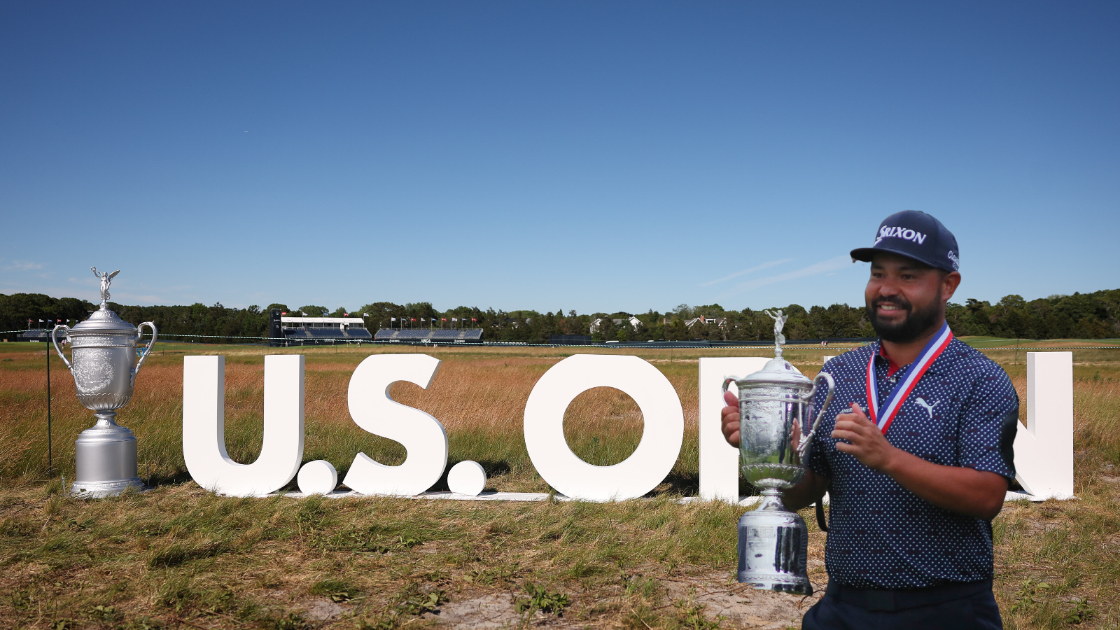 JJ Spaun holds up U.S. Open trophy