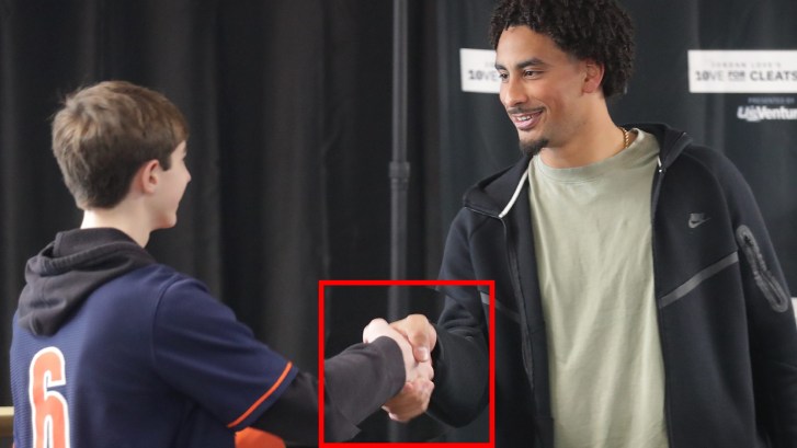 Jordan Love shaking hands with a kid