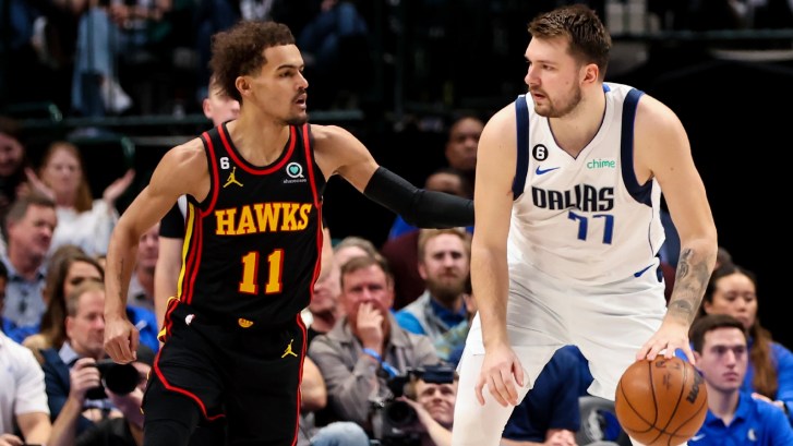 Luka Doncic guarded by Trae Young