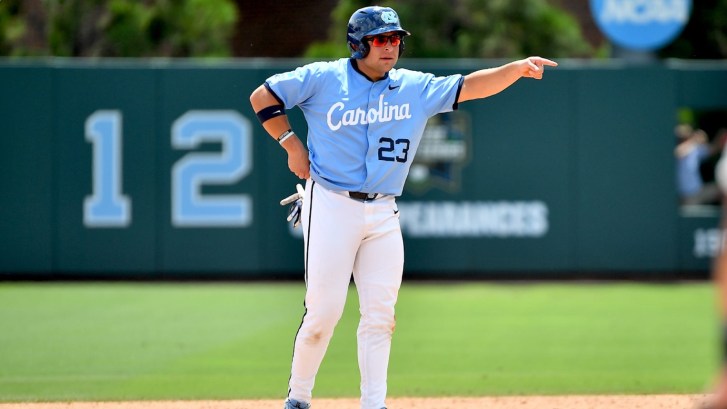 A North Carolina baseball player signals to the dugout