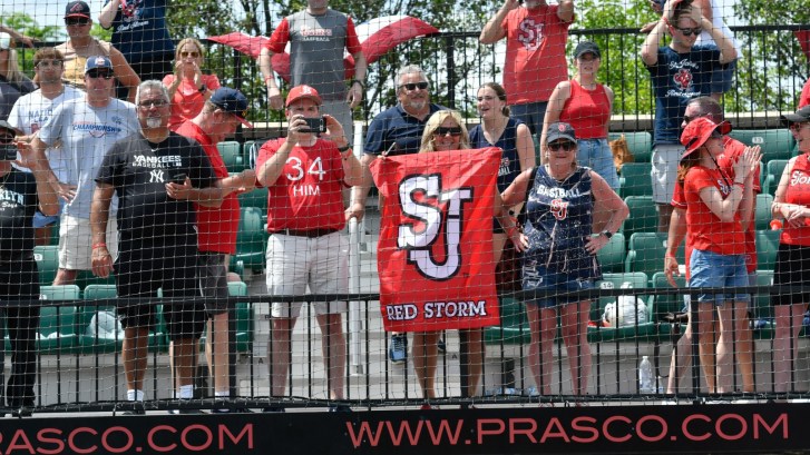 A fan waves a St. John's baseball flag