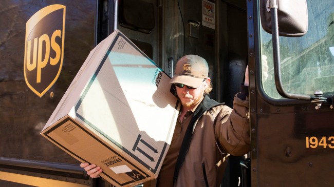 UPS driver hauling box out of truck