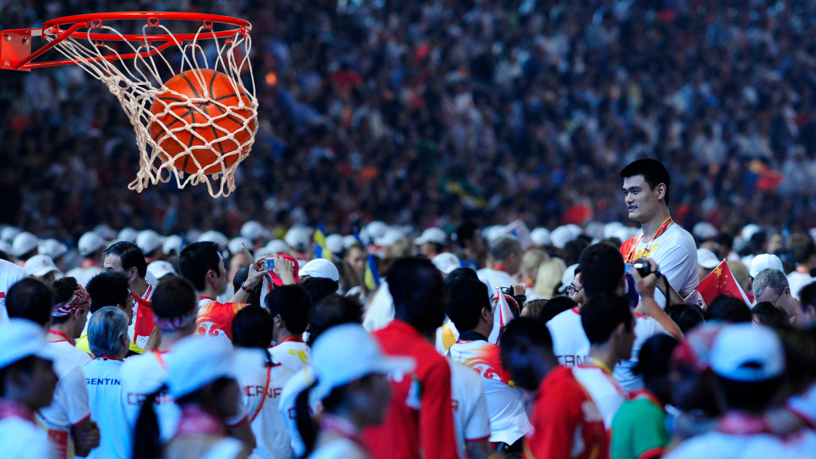 Yao Ming standing over a crowd as one of tallest basketball players of all time