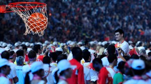 Yao Ming standing over a crowd as one of tallest basketball players of all time