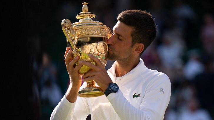 Novak Djokovic holds up Wimbledon trophy after winning