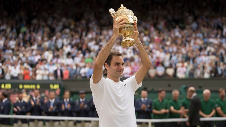 Roger Federer holds up 2017 Wimbledon trophy