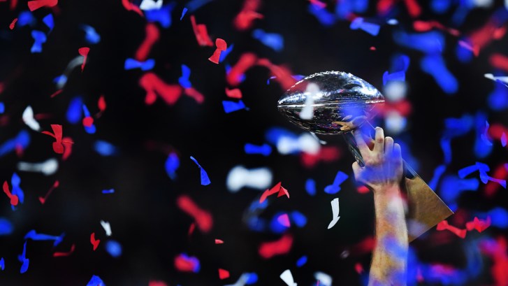New England Patriots legend Tom Brady holds up Lombardi Trophy