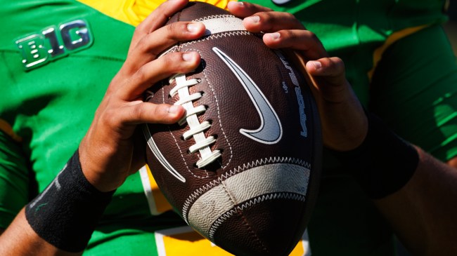 Oregon QB holding football