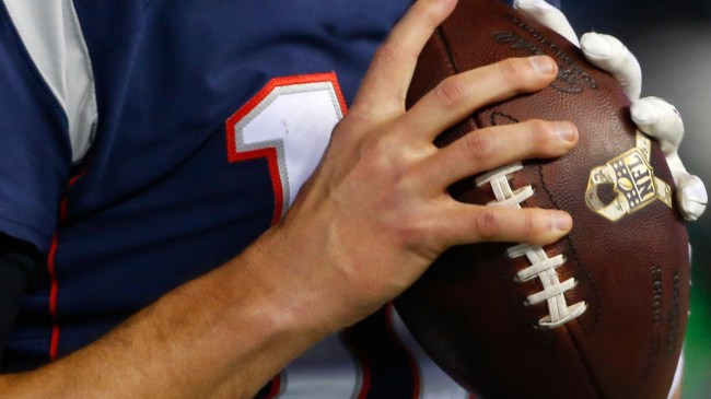 Tom Brady holding football