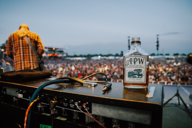 Derek Trucks playing at Bourbon and Beyond in Louisville, Kentucky with bottle of his Ass Pocket Whiskey