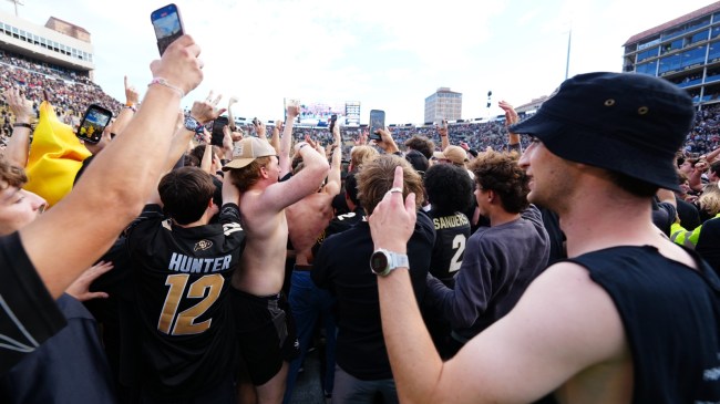 Colorado football fans storm the field after a win over Iowa State.