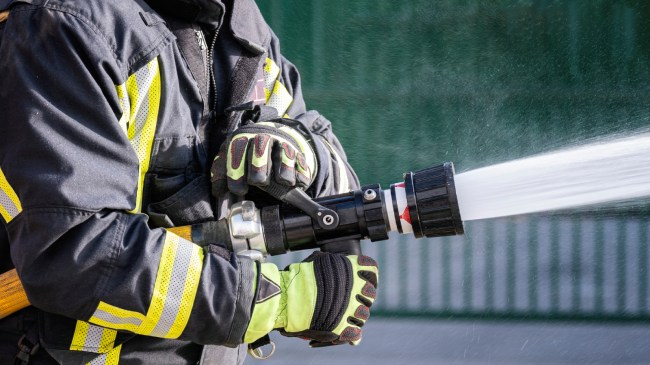 firefighter spraying hose