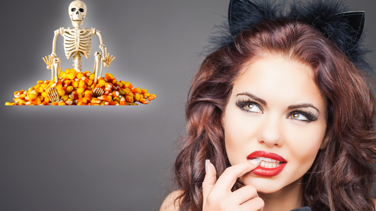 Woman dressed in Halloween cat costume staring at a skeleton sitting on Halloween candy corn