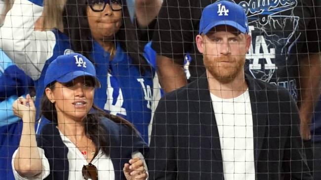 Meghan Markle and Prince Harry wearing Dodgers hats at the World Series
