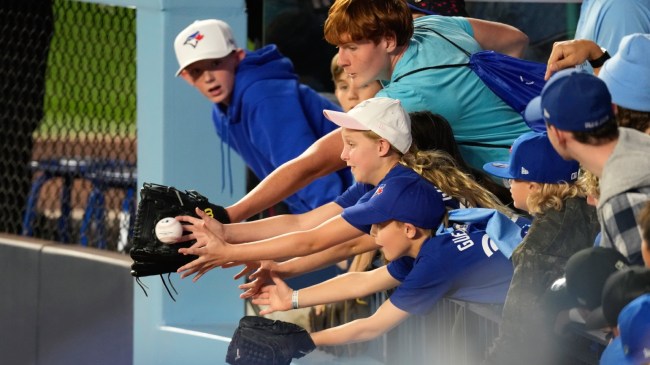 Toronto Blue Jays fans reach for a foul ball at the World Series.