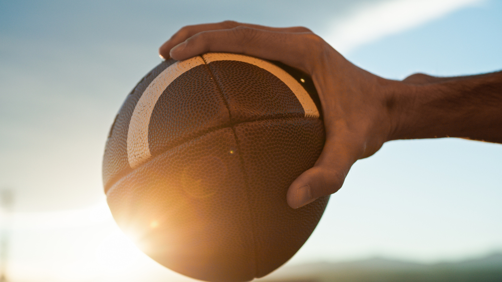 receiver palming a leather football