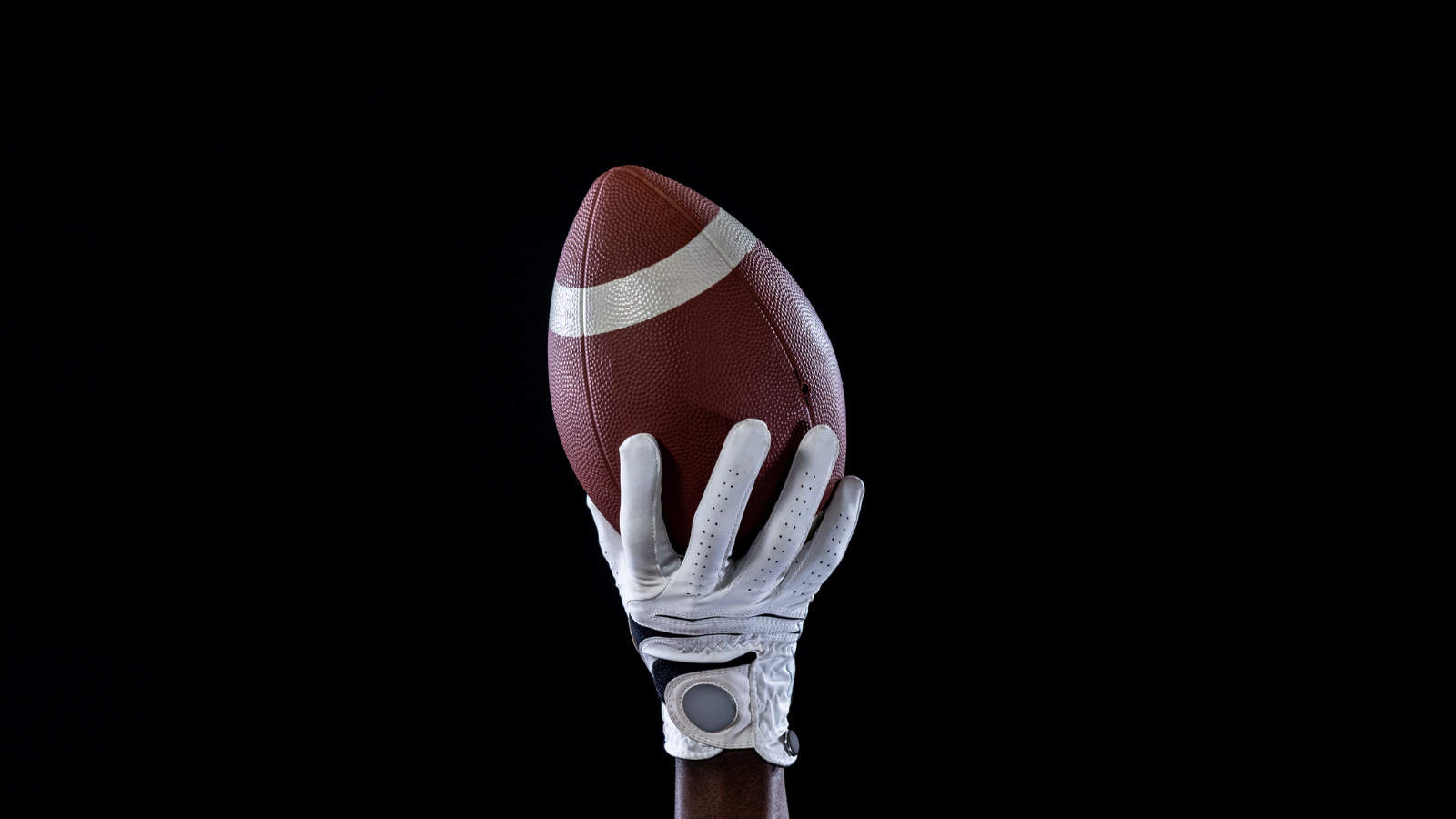 receiver's hands catching an American football