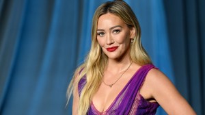 Actress and singer Hilary Duff posing in a purple gown