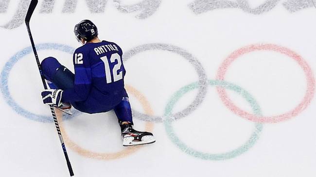 hockey player skating on Olympic rings
