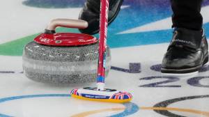 Curling stone and broom at Winter Olympics