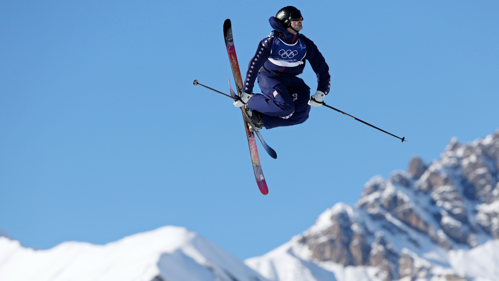 Team USA skier Alex Hall holding a jump on freestyle ski run