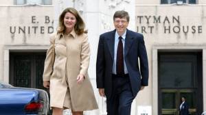 Microsoft Chairman Bill Gates arrives with his wife Melinda at U.S. Federal Court in Washington to testify in the government's anti-trust suit against his software company on April 22, 2002.