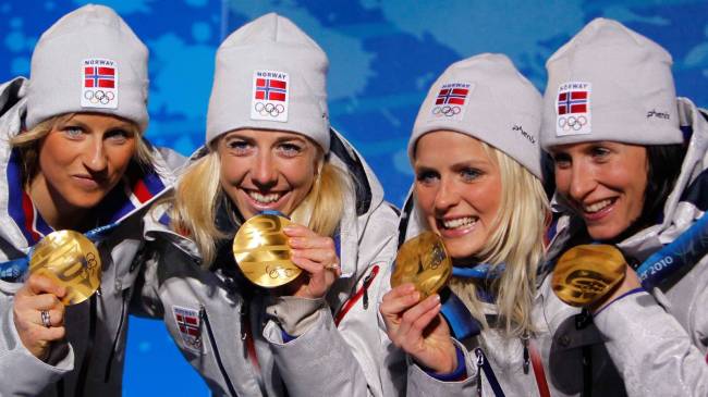 Norway women's cross coutry skiing team with gold medals at 2010 Winter Olympics