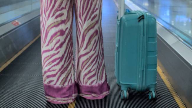 woman wearing pajamas at airport