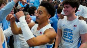 UNC players with fans who stormed court after win over Duke
