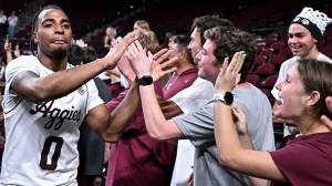 Texas A&M basketball player Marcus Hill high fives fans