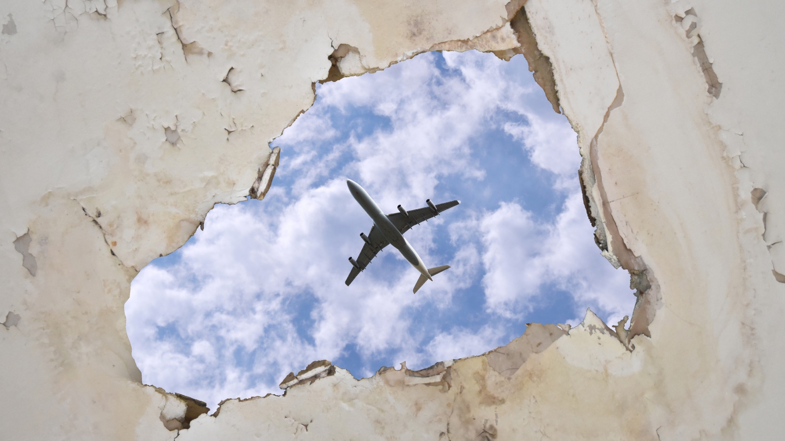 view of plane through hole in roof