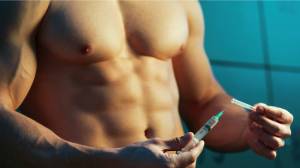 Muscular man with steroid needle