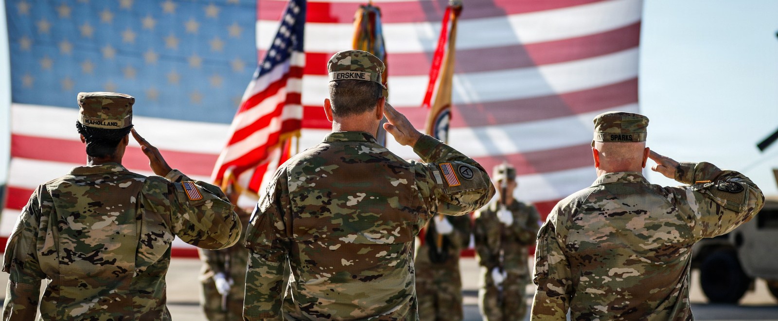 US Army soldiers saluting the flag