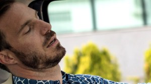 man-sleeping-behind-the-wheel