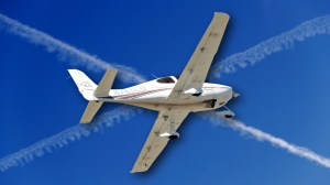 Airplane over contrails resembling the Scottish flag