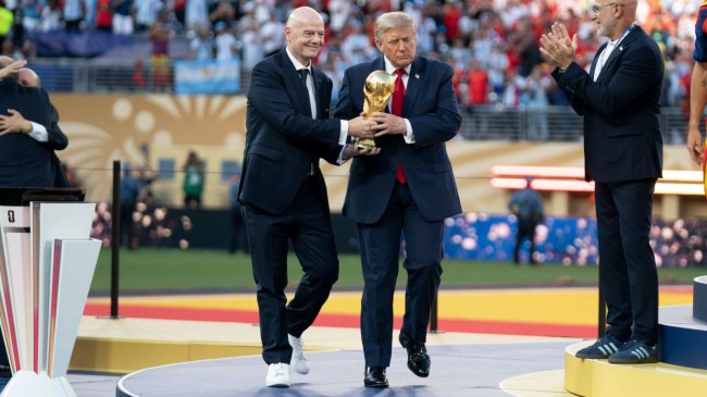 Gianni Infantino and Donald Trump carry the FIFA World Cup trophy
